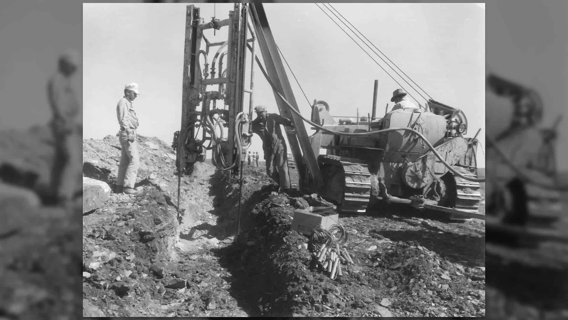 Team members with equipment working on the Blackwell-Graham crossline construction (1955)