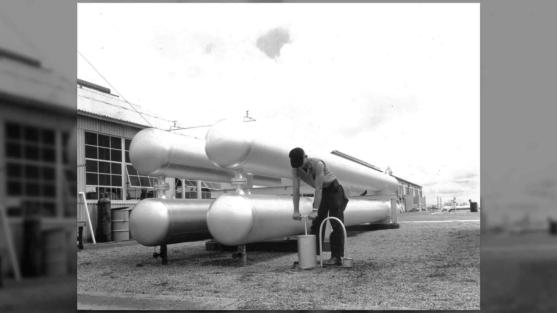 A team member working outside the Alva Compressor Station (July, 1958)