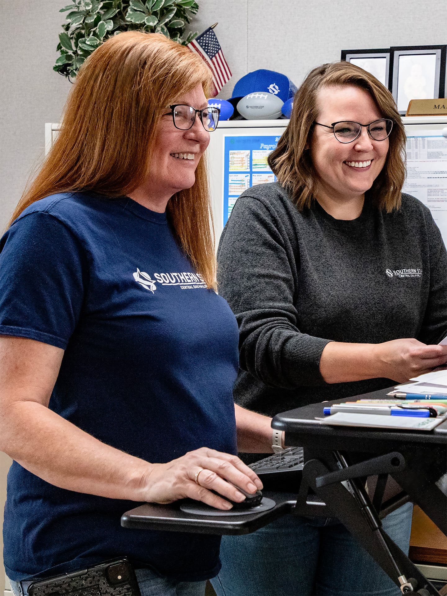 Two Southern Star workers standing beside each other looking at a computer screen.