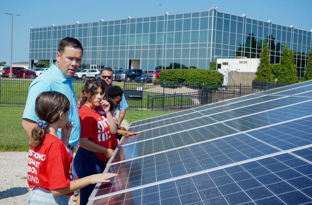 Kids looking at a solar panel at Southern Star headquarters