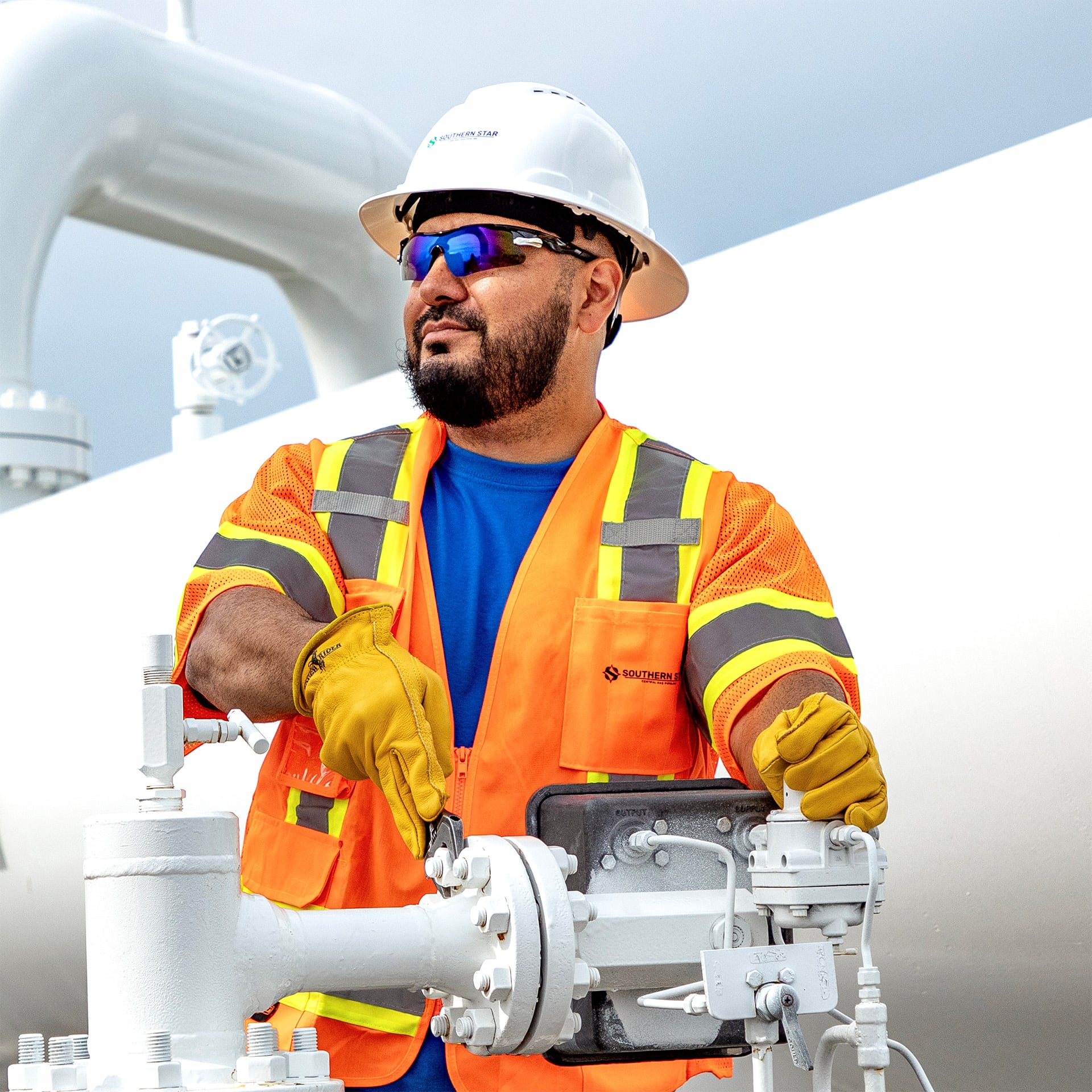 Background Image, man in hard hat looking off in the distance.