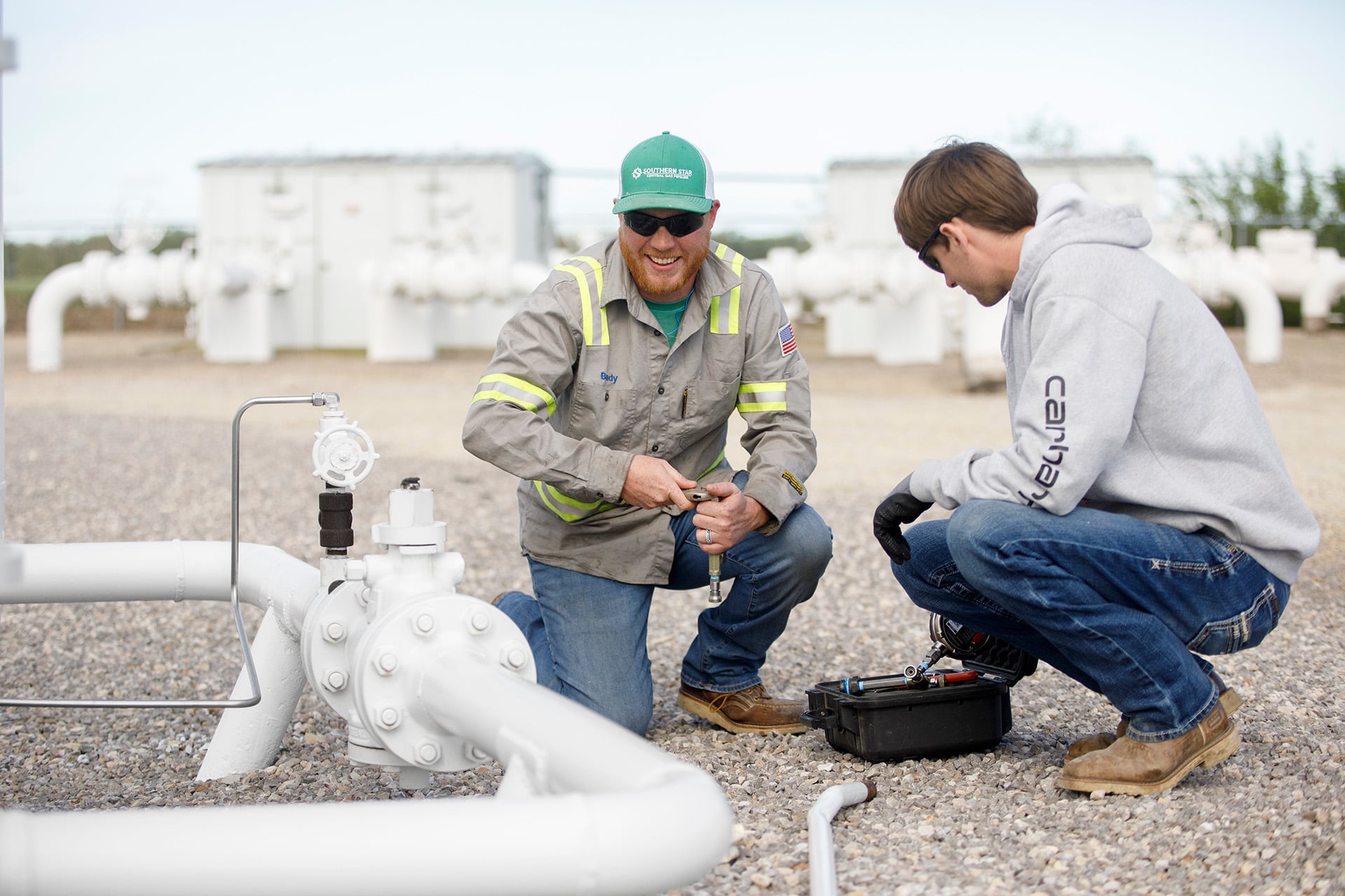 Two workers working on a gas line