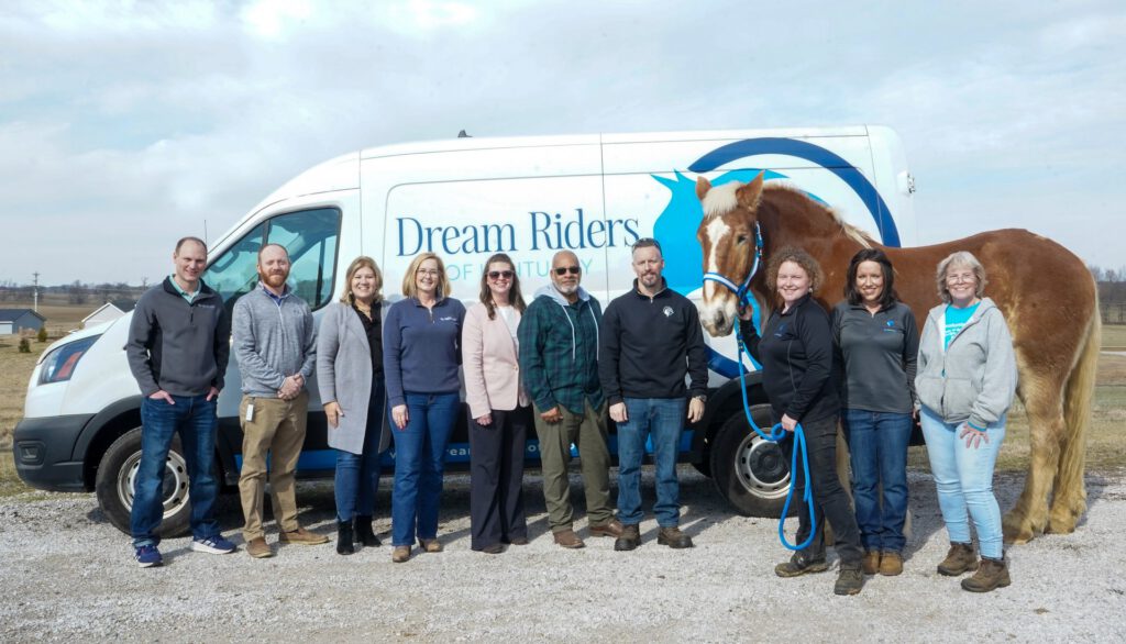 Southern Star Cares and Dream Riders team members pose for a group photo with the horse Star.